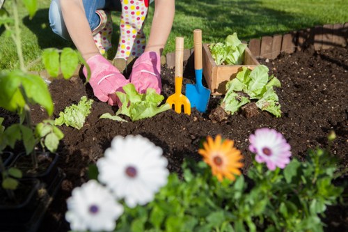 Company logo overlaid on garden tools representing Gardener Bayswater commitment